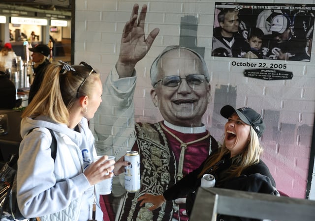 Andrea Burns, left, and Martina Maggiore find the recently installed mural of Pope Leo XIV in Section 140 before a White Sox-Rangers game at Rate Field on May 23, 2025. Chicagoans can buy tickets to a June 14 citywide celebration of Pope Leo XIV&#39;s election beginning Friday, the Archdiocese of Chicago announced. (John J. Kim/Chicago Tribune)