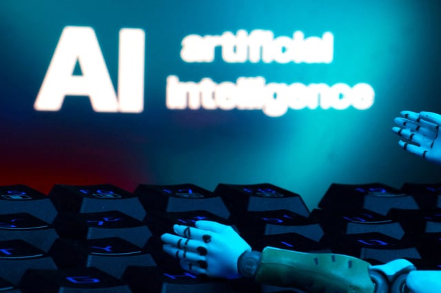 A message reading "AI artificial intelligence," a keyboard and robot hands are seen in this illustration created on January 27, 2025. REUTERS/Dado Ruvic/Illustration/File Photo