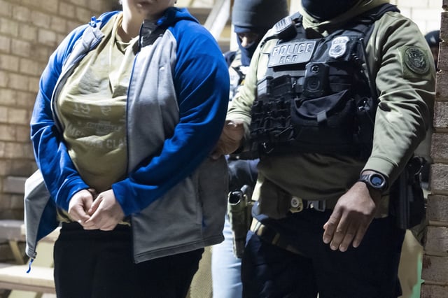 FILE - U.S. Immigration and Customs Enforcement officers detain a person, left, Monday, Jan. 27, 2025, in Silver Spring, Md. (AP Photo/Alex Brandon, File)