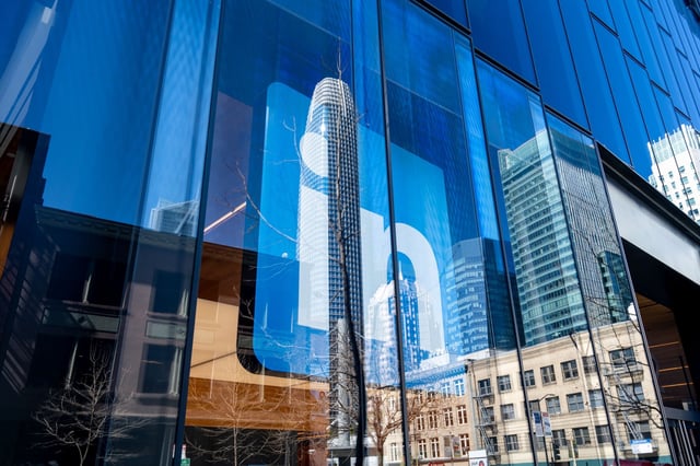 LinkedIn’s logo is displayed on a glass facade reflecting Salesforce Tower in San Francisco’s SoMa neighborhood on March 18, 2025. The social networking company uses an office on Second Street.