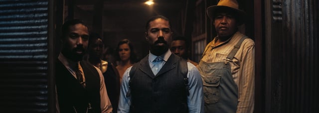 Smoke (Michael B. Jordan, center), flanked by brother Stack (also Jordan) and pal Cornbread (Omar Miller), are wary of some uninvited guests in the period horror film "Sinners."