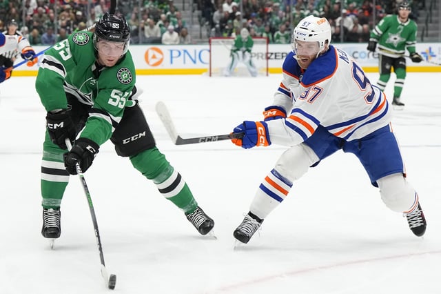 Thomas Harley #55 of the Dallas Stars is defended by Connor McDavid #97 of the Edmonton Oilers during the first period at American Airlines Center on February 17, 2024 in Dallas, Texas.