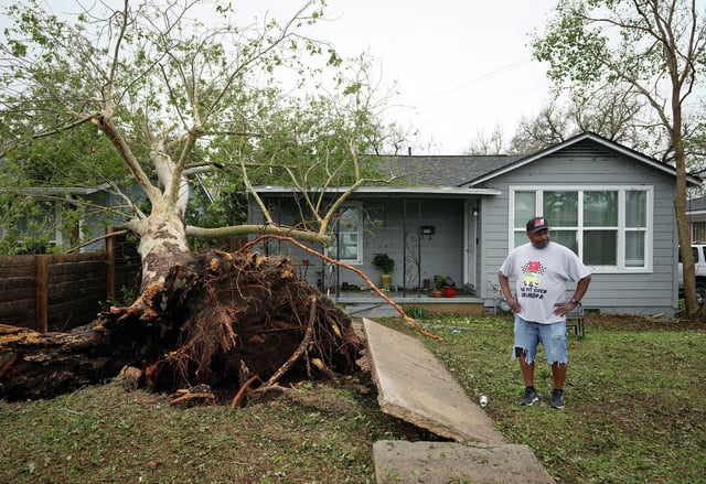 Charles White looks at the damage to his rental property on Leslie Avenue in East Austin, Thursday, May 29, 2025, after a large tree fell during a storm Wednesday. “We’ve never seen anything like this,” said White, who has lived in the neighborhood his whole life.