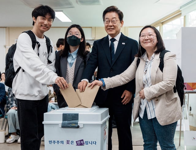 Lee Jae-myung, the presidential candidate for South Korea's Democratic Party, poses for photographs as he casts his early vote for the upcoming presidential election with his supporters at a polling station in Seoul, South Korea, May 29, 2025.      Yonhap via REUTERS