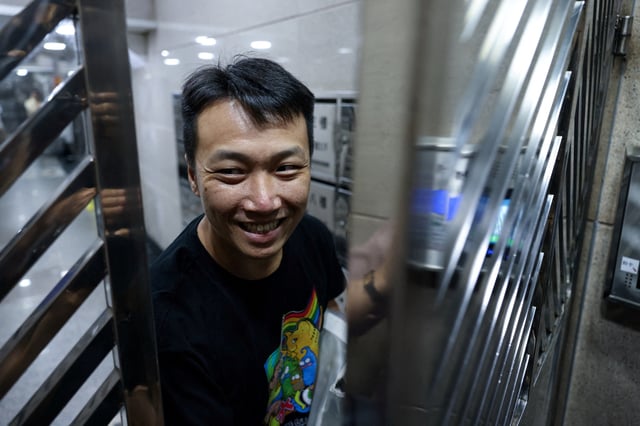 Pro-democracy and LGBT+ rights activist Jimmy Sham Tsz-kit arrives at his residence after serving a four-year and three-month sentence for conspiracy to commit subversion in a landmark national security case, in Hong Kong, China, May 30, 2025. REUTERS/Tyrone Siu
