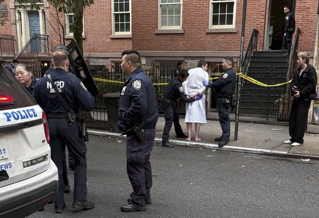 New York police officers arrest John Woeltz, Friday, May 23, 2025, in New York, who was charged with kidnapping, assaulting and holding a man against his will for several weeks in an upscale Manhattan town house.(AP Photo/Kava Gorna via AP)