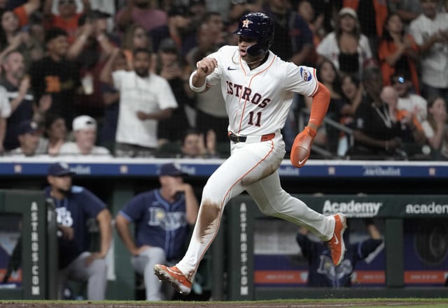 Houston Astros Cam Smith scores on Mauricio Dubón’s RBI single during the fifth inning of an MLB baseball game in Houston, Thursday, May 29, 2025.