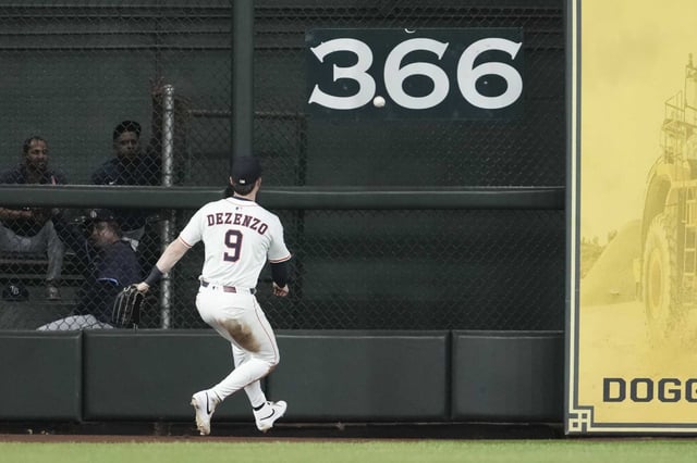 Houston Astros left fielder Zach Dezenzo plays a 2-RBI double by Tampa Bay’s Junior Caminero off the wall during the eighth inning of an MLB baseball game in Houston, Thursday, May 29, 2025.