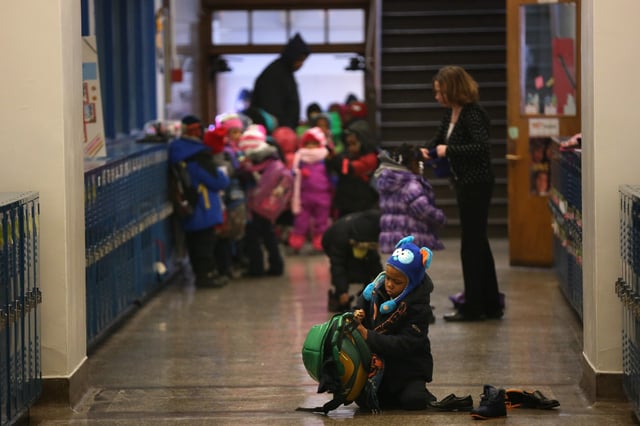 Students wait in the hallway at Alain Locke Charter School on Jan. 23, 2014. Alain Locke was among the sixteen charter school that the Chicago Board of Education voted Thursday to renew the contracts. It was set to expire at the end of June.(E. Jason Wambsgans/Chicago Tribune)