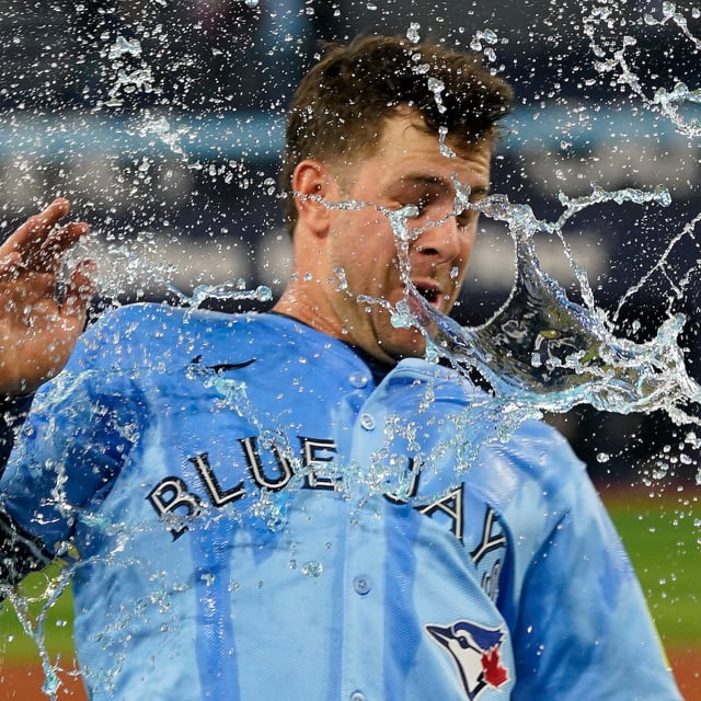 May 29, 2025; Toronto, Ontario, CAN; Toronto Blue Jays third baseman Ernie Clement (22) gets doused with water after win over the Athletics at Rogers Centre. Mandatory Credit: John E. Sokolowski-Imagn Images