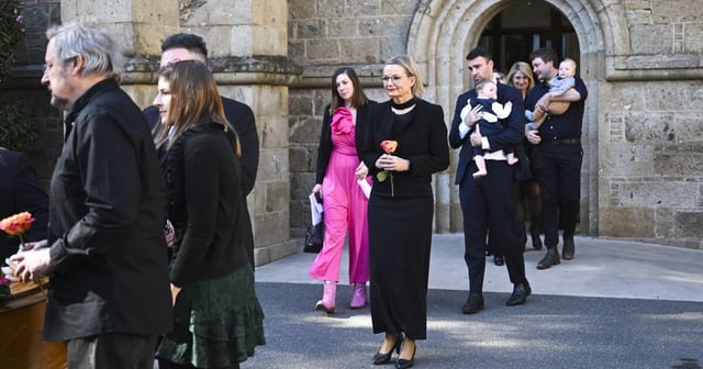 Opposition leader Sussan Ley stands behind her mother's coffin as it is placed into a hearse outside St Matthew's Anglican Church following funeral rites. Picture by Mark Jesser