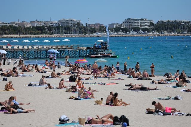 People enjoy the sun on a beach of the Croisette during the 78th Cannes Film Festival in Cannes, France, May 15, 2025. REUTERS/Stephane Mahe/File Photo