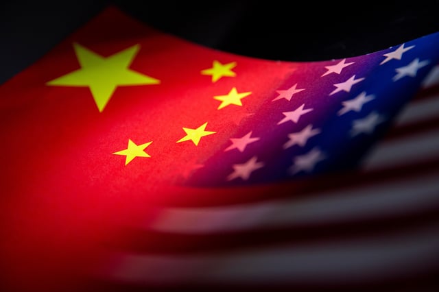 China's and U.S.' flags are seen printed on paper in this illustration taken January 27, 2022. REUTERS/Dado Ruvic/Illustration/File Photo