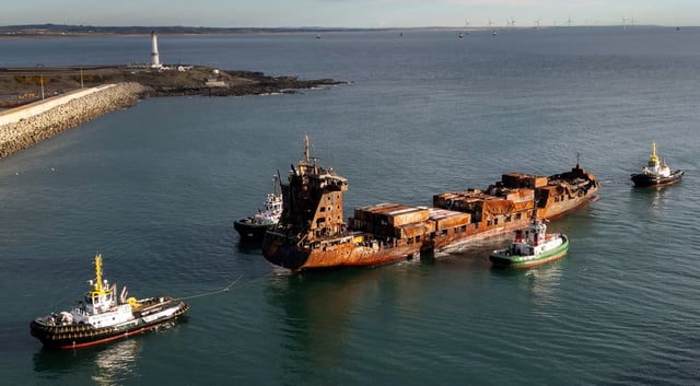 A drone view shows the container ship Solong, damaged as a result of colliding with the anchored Stena Immaculate oil tanker ship, towed by tug boats into the port of Aberdeen, Scotland, Britain, March 28, 2025. REUTERS/Phil Noble/ File Photo