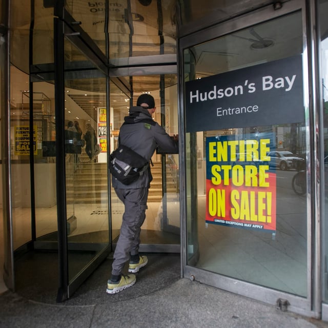 A shopper enters the Hudson’s Bay store on Queen St. West in Toronto’s Financial District on May 29, 2025. Signs say the store will be closing down in four days. (Fred Lum/The Globe and Mail).