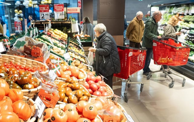 Una mujer compra verdura en un supermercado.