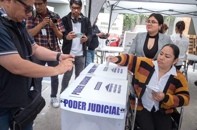 Cecilia Xitlali Diaz Aguirre casts a sample ballot during a voting process demonstration on May 23 in Tijuana before Mexico’s inaugural judicial elections set for Sunday . (David Maung / For The San Diego Union-Tribune)