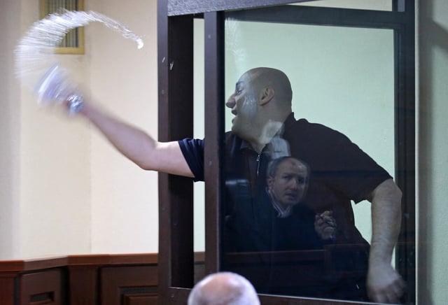 Nika Melia, one of the leaders of the Coalition for Change opposition group, charged with failing to appear before the Georgian parliament's temporary investigative commission, splashes water towards a judge during a court hearing in Tbilisi, Georgia May 30, 2025. REUTERS/Irakli Gedenidze/Pool