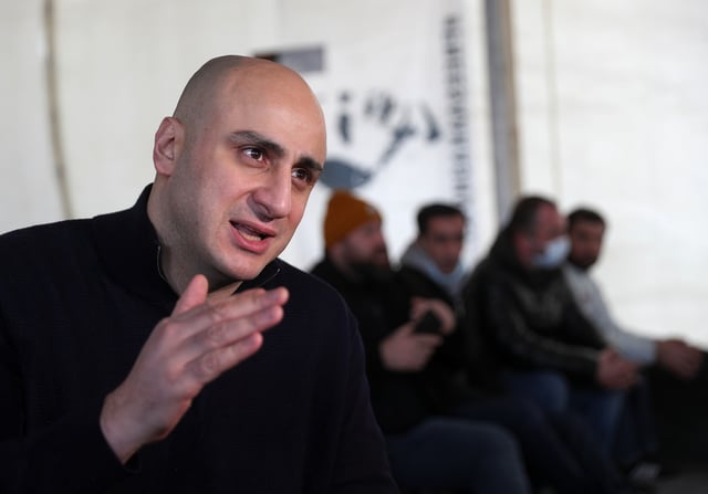 Nika Melia, leader of Georgia's largest opposition party United National Movement (UNM), and his supporters gather in a tent outside the party's office after they announced a hunger strike to demand the immediate release of jailed ex-president Mikheil Saakashvili in Tbilisi, Georgia December 22, 2021. REUTERS/Irakli Gedenidze/ File Photo