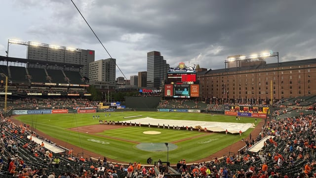 The tarp is rolled out at Oriole Park at Camden Yards during a rain delay Saturday against the Royals. (Matt Weyrich/Staff)