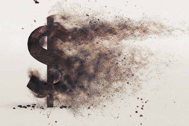 A photo illustration of a dollar sign up in flames