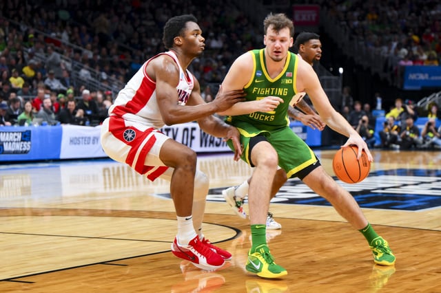 Mar 23, 2025; Seattle, WA, USA;  Oregon Ducks center Nate Bittle (32) dribbles the ball against Arizona Wildcats forward Tobe Awaka (30) in the first half at Climate Pledge Arena. Mandatory Credit: Steven Bisig-Imagn Images/File Photo