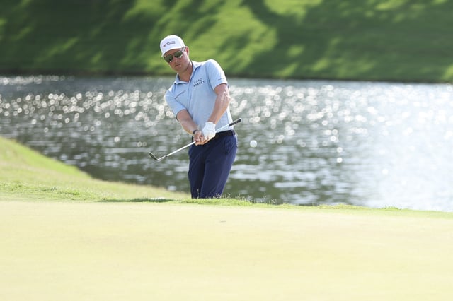 Ben Griffin of the United States chips onto the 18th green during the final round of the Charles Schwab Challenge 2025 at Colonial Country Club on May 25, 2025 in Fort Worth, Texas.