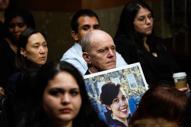Chris Moore holds a photo of his daughter Danielle Moore, who died in the crash of Ethiopian Airlines flight 302, during a US Senate Homeland Security and Governmental Affairs Subcommittee on Investigations hearing.