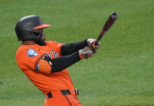 Orioles’ Cedric Mullins follows through on his two-run double against the Blue Jays in the sixth inning. The Orioles defeated the Blue Jays 5-4 at Oriole Park at Camden Yards. (Kenneth K. Lam/Staff)