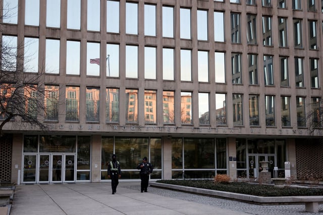 Security members walk outside the headquarters of the Office of Personnel Management in Washington, DC, on February 13.