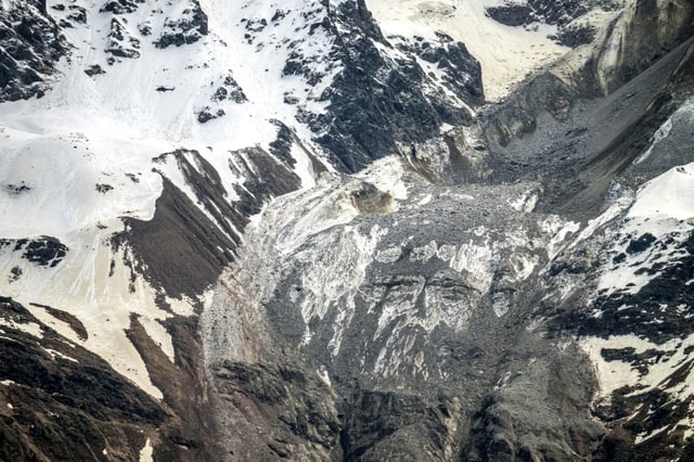 A Swiss air force helicopter flies above the scene of the collapsed Birch Glacier