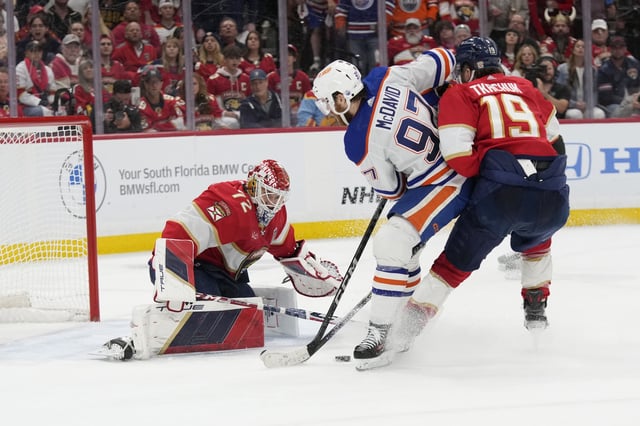 Florida Panthers goaltender Sergei Bobrovsky (72) and left wing Matthew Tkachuk (19) defend the net from a shot by Edmonton Oilers centre Connor McDavid (97) during the third period of Game 2 of the NHL hockey Stanley Cup Finals, Monday, June 10, 2024, in Sunrise, Fla. 