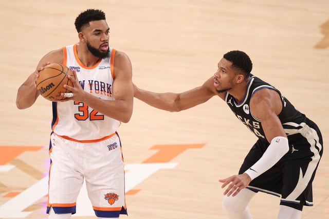 NEW YORK, NEW YORK - JANUARY 12: Karl-Anthony Towns #32 of the New York Knicks handles the ball defended by Giannis Antetokounmpo #34 of the Milwaukee Bucks during the first half at Madison Square Garden on January 12, 2025 in New York City.