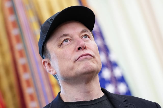 Tesla CEO Elon Musk listens as U.S. President Donald Trump speaks to reporters in the Oval Office of the White House on May 30, 2025 in Washington, DC. Musk, who served as an adviser to Trump and led the Department of Government Efficiency, left his role in the Trump administration early this week to refocus on his businesses.