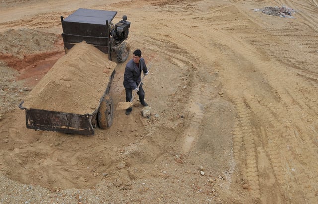 A  labourer works at a site of a rare earth metals mine at Nancheng county, Jiangxi province March 14, 2012. REUTERS/Stringer CHINA OUT. NO COMMERCIAL OR EDITORIAL SALES IN CHINA/File Photo