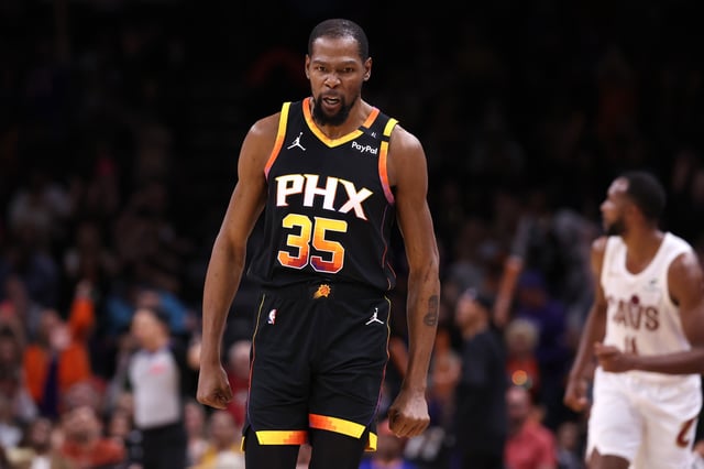PHOENIX, ARIZONA - MARCH 21: Kevin Durant #35 of the Phoenix Suns reacts after hitting a three point basket during the second half against the Cleveland Cavaliers at PHX Arena on March 21, 2025 in Phoenix, Arizona.