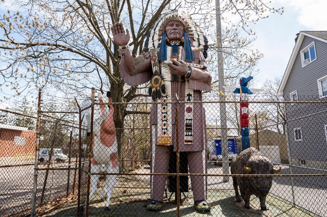 A Big Chief Lewis statue is surrounded by a fence in Massapequa, N.Y., Friday, April 25, 2025. (AP Photo/Julia Demaree Nikhinson)