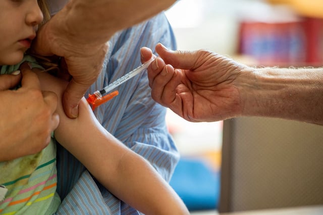 A young child receives a Moderna Covid-19 6 months to 5 years vaccination at Temple Beth Shalom in Needham, Massachusetts on June 21, 2022. The temple was one of the first sites in the state to offer vaccinations to anyone in the public.. US health authorities on Saturday cleared the Pfizer and Moderna Covid-19 vaccines for children aged five and younger, in a move President Joe Biden greeted as a "monumental step" in the fight against the virus.