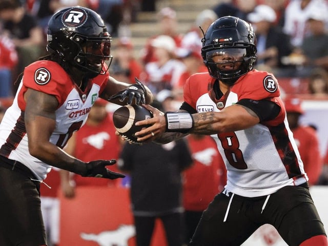  Ottawa Redblacks quarterback Jeremiah Masoli hands the ball off to Bralon Addison Aug. 15, 2024.