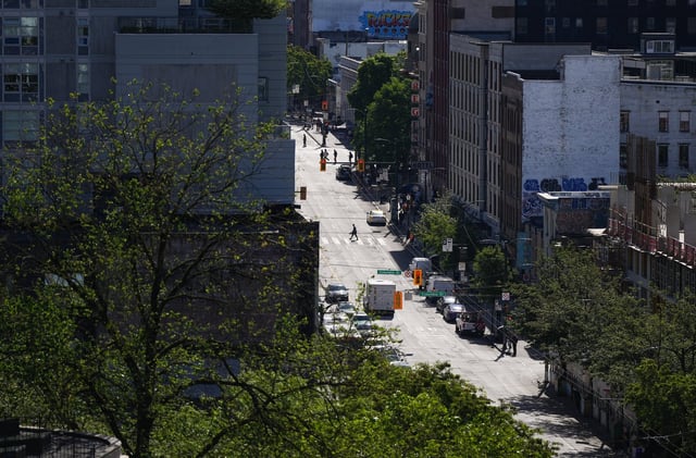 Pedestrians cross East Hastings Street in the Downtown Eastside of Vancouver, on Thursday, June 13, 2024. THE CANADIAN PRESS/Darryl Dyck