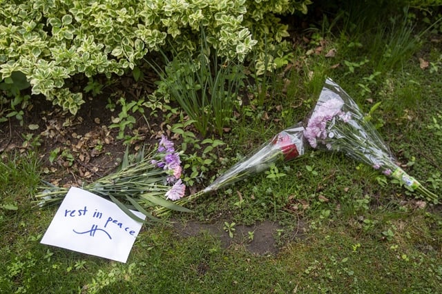  A message of “rest in peace” is seen among bouquets of flowers left outside the home. ERNEST DOROSZUK/TORONTO SUN