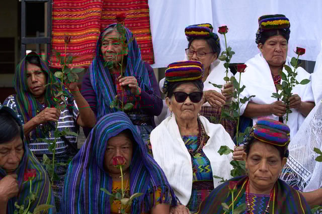 Indigenous women wait outside the Supreme Court to wait for an expected ruling, by a different court, in a case against three former paramilitary fighters who were trained by the military and are accused of raping 36 women four decades ago during Guatemala's civil war, in Guatemala City, Friday, May 30, 2025. (AP Photo/Moises Castillo)