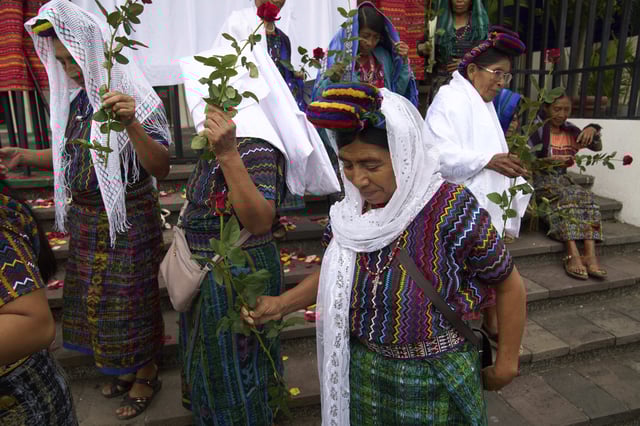 Indigenous women arrive outside the Supreme Court to wait for an expected ruling, by a different court, in a case against three former paramilitary fighters who were trained by the military and are accused of raping 36 women four decades ago during Guatemala's civil war, in Guatemala City, Friday, May 30, 2025. (AP Photo/Moises Castillo)