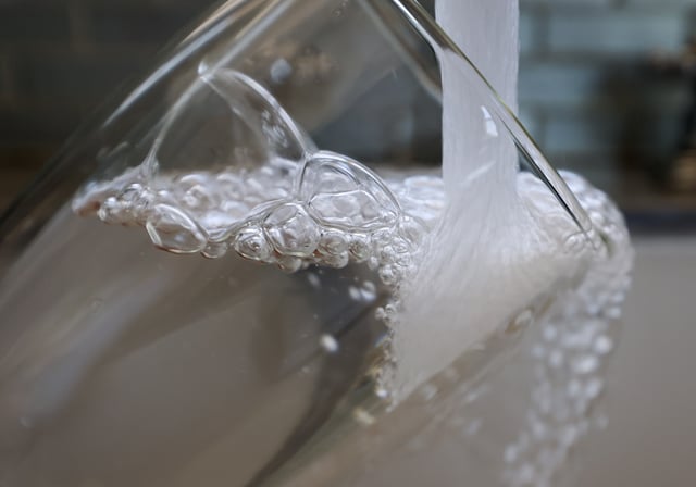 MIAMI, FLORIDA - MAY 16: In this photo illustration, water runs from a kitchen faucet on May 16, 2025 in Miami, Florida. Florida Gov. Ron DeSantis signed a bill into law that will ultimately ban fluoride from the state's water system, going into effect on July 1. (Photo illustration by Joe Raedle/Getty Images)