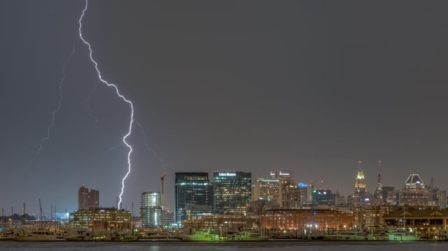 A thunderstorm over Baltimore City produces a lightning strike over the city.