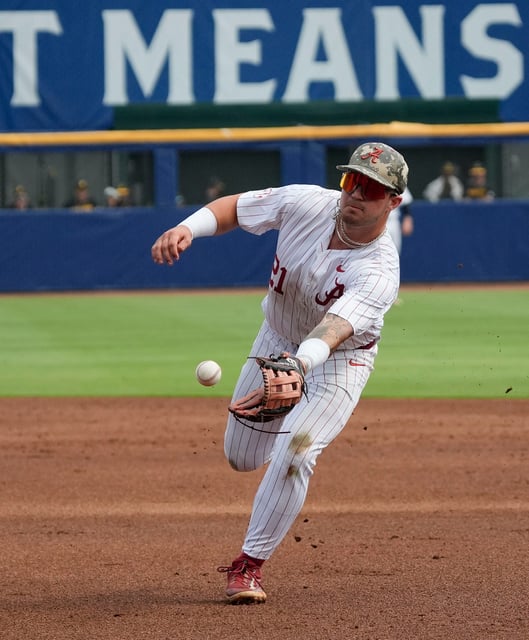 May 20, 2025; Hoover, AL, USA; Alabama second baseman Brennen Norton (21) fields and flips to first on a slow roller to second during the game with Missouri in the first game of the SEC Baseball Tournament at the Hoover Met.