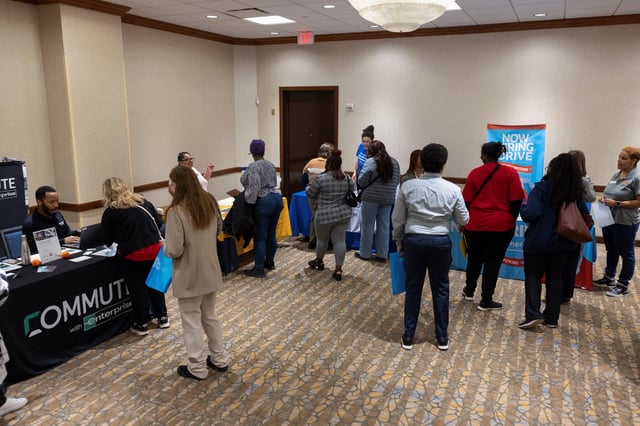 People speak with job placement and professional development representatives during a job fair for federal workers fired in recent weeks through job cuts, organized by the National Treasury Employees Union (NTEU) in Kansas City, Missouri, U.S. March 15, 2025.  REUTERS/Chase Castor/File Photo