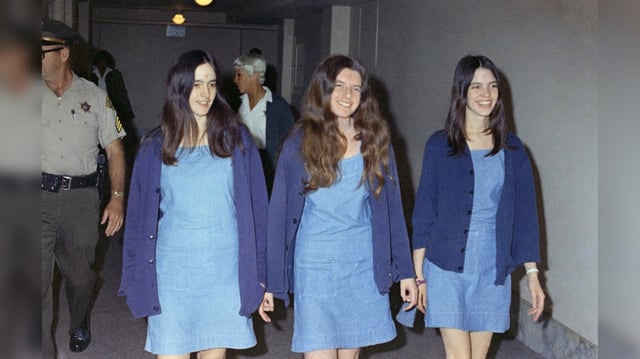 FILE – In this Aug. 20, 1970, file photo, Charles Manson followers, from left, Susan Atkins, Patricia Krenwinkel and Leslie Van Houten walk to court to appear for their roles in the 1969 cult killings of seven people in Los Angeles. Timing alone ensures that the Woodstock music festival and Charles Manson murders will be joined in memory. But the apex of peace and love and the abyss of pitiless violence were born out of similar drives as old as the U.S. itself. (AP Photo/George Brich, File)
