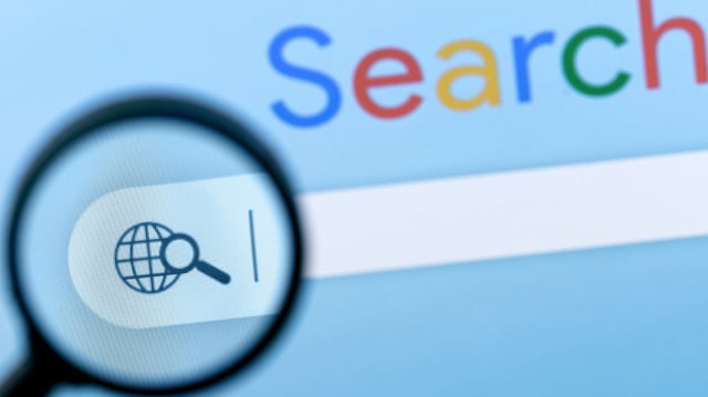 Internet search bar in browser with magnifier on computer monitor screen. stock photo