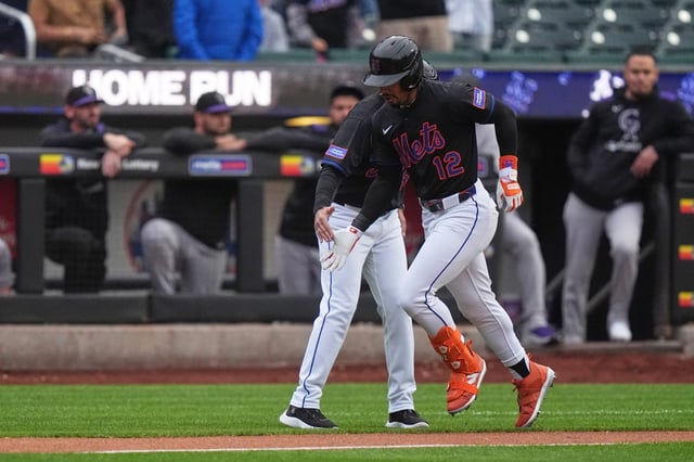 New York Mets&#39; Francisco Lindor (12) celebrates with third base coach Mike Sarbaugh as he runs the bases after hitting a home run during the first inning of a baseball game against the Colorado Rockies Friday, May 30, 2025, in New York. (AP Photo/Frank Franklin II)